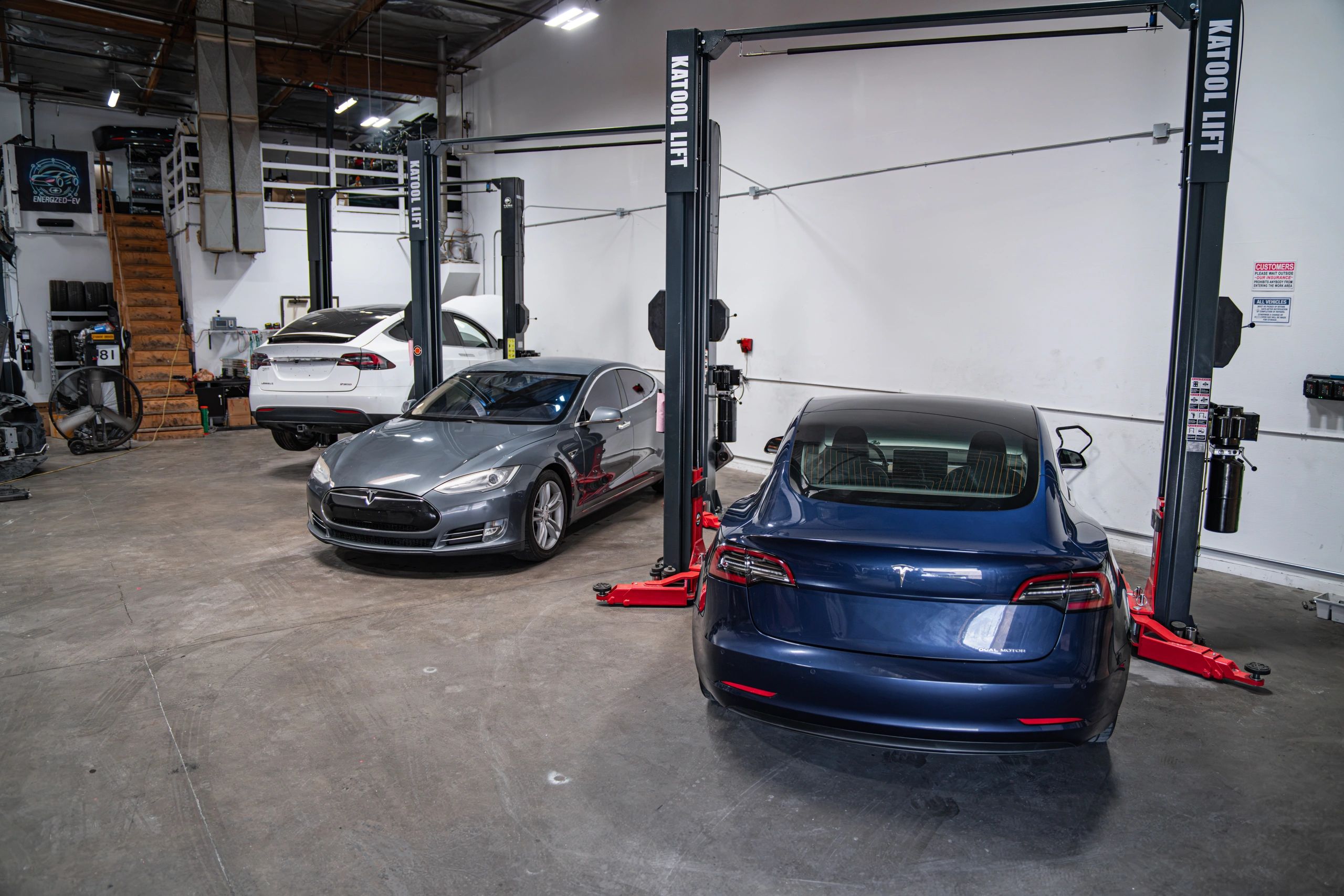 Tesla vehicles inside the Energized-EV workshop in Pomona